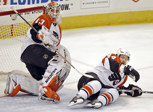 Kimmo Timonen goes down in front of Marty Biron.