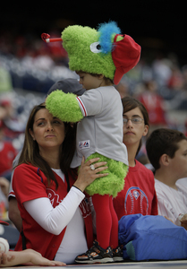 Daniel Breninghouse, 2, celebrates the Phanatic's birthday in a costume made by his mom, Emily (left).
