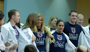 Students at Pennsylvania College of Optometry display shirts reflecting yesterday's announcement that the Elkins Park school is becoming a university and changing its name. The new name will be Salus University, with "salus" being Latin for "health and well-being." The school says the name reflects a strengthened curriculum and new programs. It will continue to offer optometric programs and degrees, a full audiology program, and a physician-assistant program.