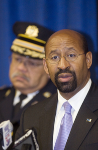 Mayor Nutter, with Commissioner Charles Ramsey in background, at news conference over hearing on city gun laws yesterday.