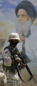 An Iraqi soldier stands guard before a portrait of Mohammed Sadiq al-Sadr, the late father of the radical anti-U.S. cleric Muqtada al-Sadr.
