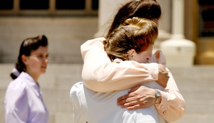 Two members of the Fundamentalist Church of Jesus Christ of Latter Day Saints hug outside court yesterday after learning appeals judges ruled that the state shouldn't have seized their children.