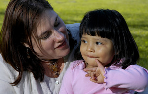 Deborah Surine , a Cornell University employee, poses with her daughter Olivia, whom she adopted from Guatemala with help from the school.