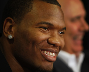 Marreese Speights talks to media with GM Ed Stefanski in background.