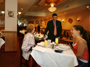 At King of Tandoor, Abul Kalam Azad waits on Barbara Rex (left) and Irene Trantas. One of the city's posher Indian restaurants, it is new at 1824 Callowhill St. in Franklintown.