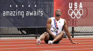 Tyson Gay sprawls on the track after his injury in a heat of the 200-meter dash. With Gay out of the event, Rodney Martin (20.04 seconds) and Wallace Spearmon (20.05) posted the day's fastest times.