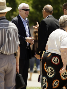 Sen. John McCain, R-Ariz., (center) talks with worshipers after leaving a service at North Phoenix Baptist Church yesterday.