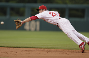 Chase Utley, shown snagging grounder hit by Mets' David Wright, notched his 25th home run of season last night; he hopes to hit many more next week in derby.