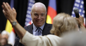 Sen. John McCain listens to a participant during a town-hall meeting in Denver. The presumptive Republican nominee called the choice "stark and simple. Sen. Obama will raise your taxes. I won't." Obama vowed tax hikes on wages topping $250,000.