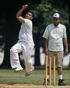 IN A LESS familiar type of bowling, at least in these parts, Ravi Dusara (left) bowls in this cricket game in Fairmount Park yesterday. In cricket, the "bowler" is like a baseball pitcher, except he throws the ball on the ground to reach a batter.