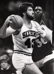 Jeff Ruland drives against Tree Rollins during one of the 116 minutes he played for the 1986-87 Sixers. "On paper, it looked like a great deal," said former general manager Pat Williams.