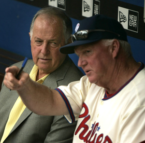 Charlie Manuel talks with general manager Pat Gillick (left) before a recent game. Once seen as a stopgap leader, Manuel is in his fourth full season as the Phillies' manager.