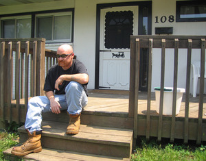 Jeff Burke, of Havertown, sits out front of his boss' home in Aston. Burke was riding his bicycle home on July Fourth after "having a few beers" and was hit by a car.