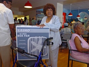 Desaderal Garris, 80, uses her walker to carry a fan she received during a giveaway at the Philadelphia Senior Center. Elderly people are considered at risk during a heat wave.