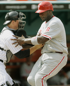 The Phillies' Ryan Howard is tagged out at the plate by Marlins catcher John Baker in the second inning.
