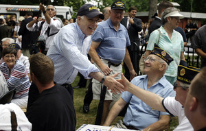 Sen. John McCain shakes hands yesterday with supporters at a campaign stop at the Maine Military Museum in South Portland.