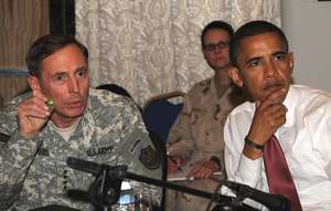 Gen. David Petraeus (left) gives an update yesterday on the Iraq situation to Sen. Barack Obama and other members of a congressional delegation in Baghdad.