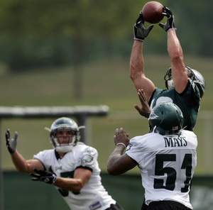 Michael Gasperson makes catch over Sean Considine and Joe Mays at training camp.