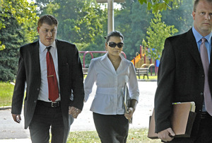 Angela Honeycutt, accused of engaging in sex acts with two teenage boys, arrives at her preliminary hearing with an unidentified man (left) and her lawyer, Niels Eriksen. Honeycutt will stand trial on charges including sexual assault and corruption of minors.