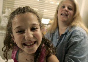 Karin Fox plays with daughter Caroline. Figuring out how to pay for therapies was "a full-time job."