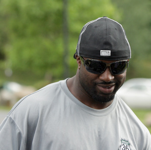 Brian Westbrook smiles before talking to media as he arrives at training camp.