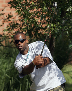 Defensive end Trent Cole practices his golf swing at Lehigh.
