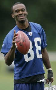 Colts receiver Marvin Harrison acknowledges fans at camp. He missed most of last season because of a left-knee injury.