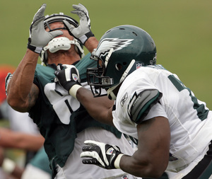 Victor Abiamiri handles tight end L.J. Smith during a drill at yesterday's morning workout.