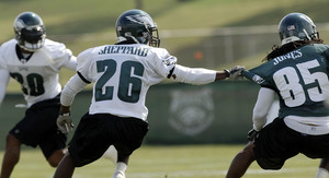 Lito Sheppard grabs wide receiver Jamal Jones at the Eagles' practice Friday while Brian Dawkins looks on. Jones was signed in the off-season; he did not play in the NFL last year.