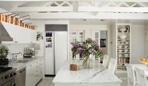 By using cabinet soffits to store pots, designer Kristina Ratia makes up for her smaller cabinets, which are 30 inches high.
