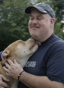 Patrick O'Donnell of Levittown , at home with his dog, Otis, was one of the postal workers sickened by the anthrax attacks in 2001.