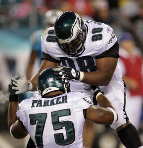 Juqua Parker, Mike Patterson celebrate a stop of Panthers quarterback Jake Delhomme.