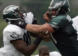 The Eagles&acute; Darren Howard (left), in a blocking drill with Todd Herremans, has been a right end but will get work on the left.