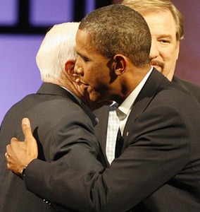 McCain and Obama embrace during their event at Saddleback Church. Pastor Rick Warren is behind them.