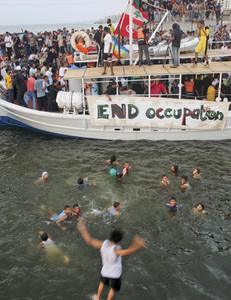 Two boats filled with activists arrive at the Gaza Strip,where they were greetedby thousands of Palestinians.