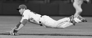 Phillies' Chase Utley makes diving stop on ball hit by Damion Easley in the eighth inning.