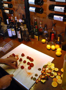 Bartender Scott Nealy cuts fruit for sangria at Bar Ferdinand. The Northern Liberties spot offers red and white versions.