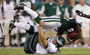 Eagles kicker David Akers tackles Jets' Ahmad Carroll during second quarter.