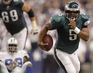 Eagles' Donovan McNabb, on the run in the second quarter, threw to nine different receivers and finished with 281 yards passing.