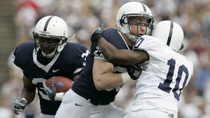 Dan Lawlor clears a path for tailback Brent Carter during Blue-White game last spring.