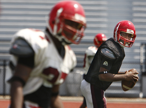 Northeast High quarterback Malik Stokes (right) eyes his brother, receiver Je'Ron Stokes. Together, they're a weapon.