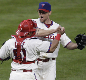 Phillies' closer Brad Lidge (right) celebrates with Carlos Ruiz after the final out against the Brewers. "A lot of the time, it takes guys getting on for me to have my best stuff," Lidge says.