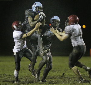 North Penn's Ronnie Akins can catch passes anytime, anywhere. Here he picks one off on defense against St. Joseph's Prep in the Knights' nonleague victory Sept. 12.