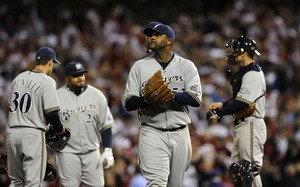 Players gather at the mound as Brewers starter CC Sabathia makes a rare early exit in the fourth inning.