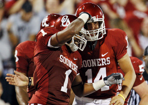 Oklahoma QB Sam Bradford (right) and WR Manuel Johnson revel after a score Saturday.
