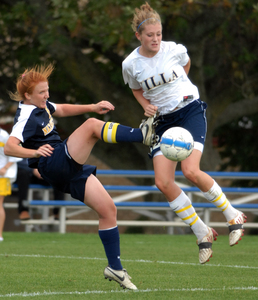 Nazareth's Kate Lazorko (left) boots a ball past Villa Joseph Marie's Meghan Ledwith in the first half of Villa's 3-0 win over the visiting Pandas in their Catholic Academies soccer match.