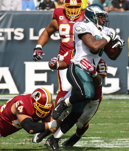 Brian Westbrook is tackled by the Redskins' Kedric Golston (left) and Rocky McIntosh after a 17-yard reception to open the game. Westbrook finished the drive with a 9-yard TD run.