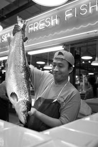 Methodios Tiko cleans salmon at the Reading Terminal Market in 2006. Depending on where it's from, salmon is either a best choice or a must to avoid.
