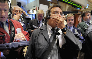 Traders on the floor of the New York Stock Exchange yesterday. At its worst point, the Dow sank 800 points, but finished down about 370. Worldwide, stock markets were plunging before Wall St. even woke up.