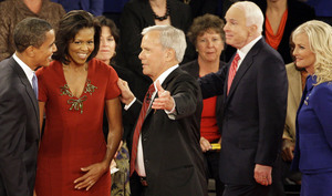 Sen. Barack Obama and his wife, Michelle, talk with debate moderator Tom Brokaw, as Sen. John McCain and his wife, Cindy, prepare to leave the auditorium after the debate.